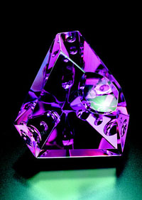 Michael Dyber gem sculpture in amethyst (48.85 carats). The holographic effects are a result of facets ground into the back or pavilion of the gem which is roughly triangular, similar to the pavilion of a standard faceted gemstone. 8Photo: Jeff Scovil